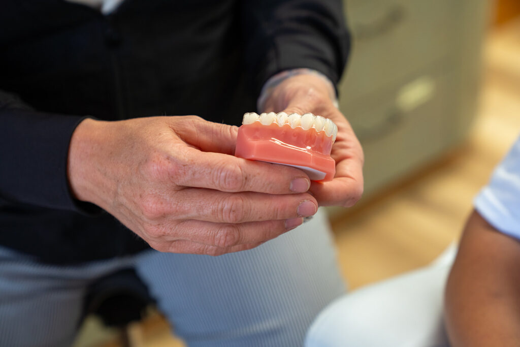 Dr Pottenger Holding A Model Of Teeth With Invisalign