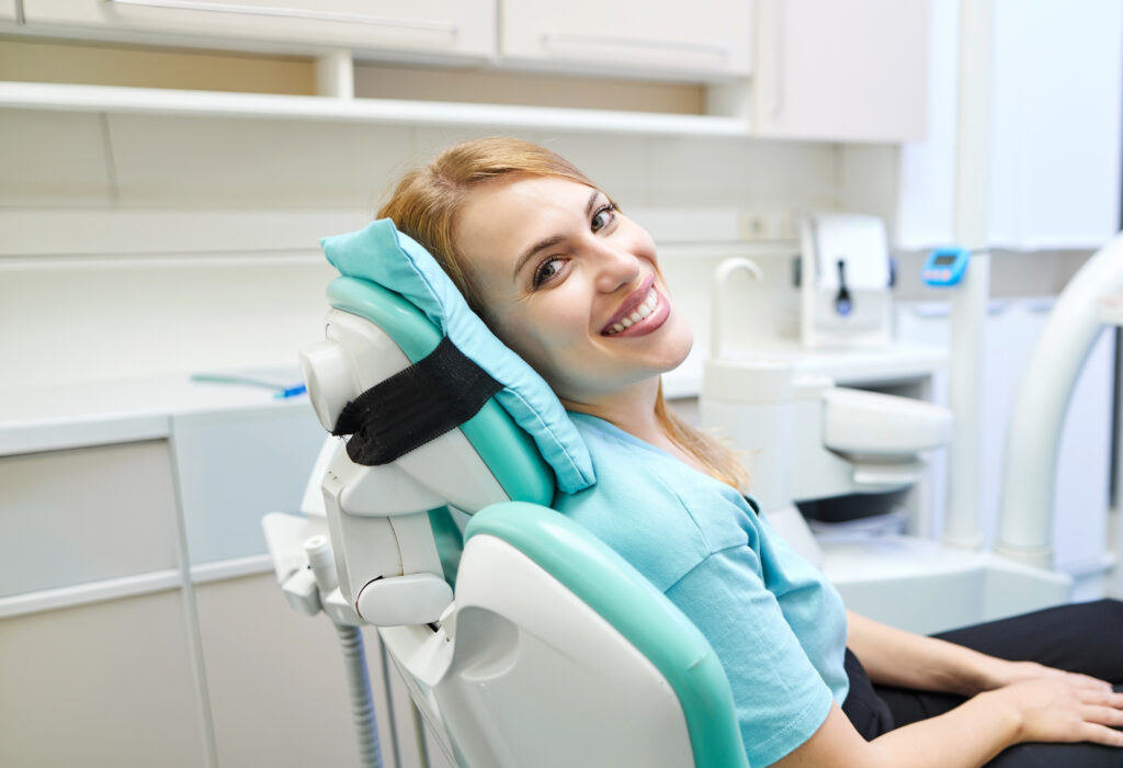 Happy Female Patient In An Examination Chair