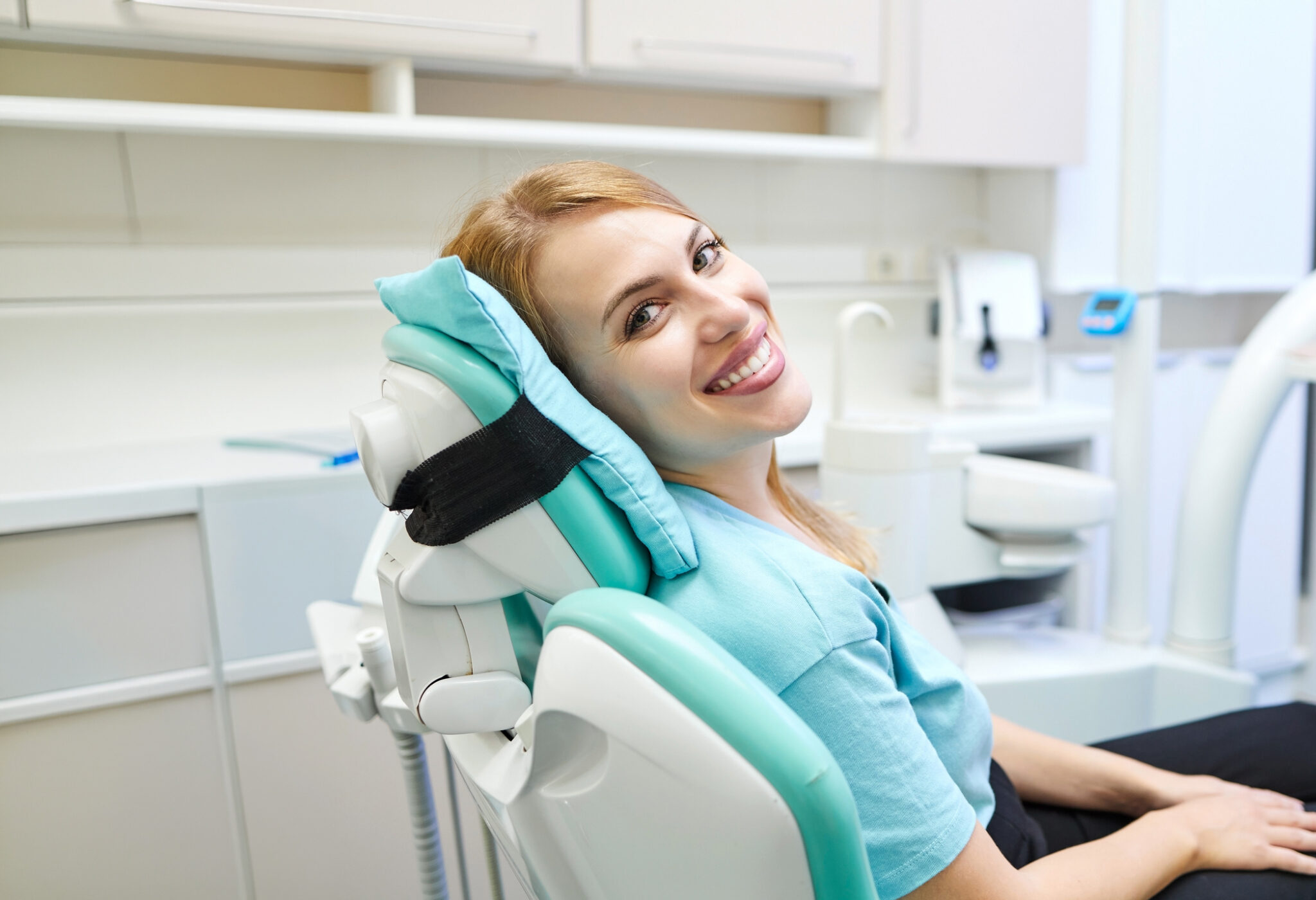 Happy Female Patient In An Examination Chair