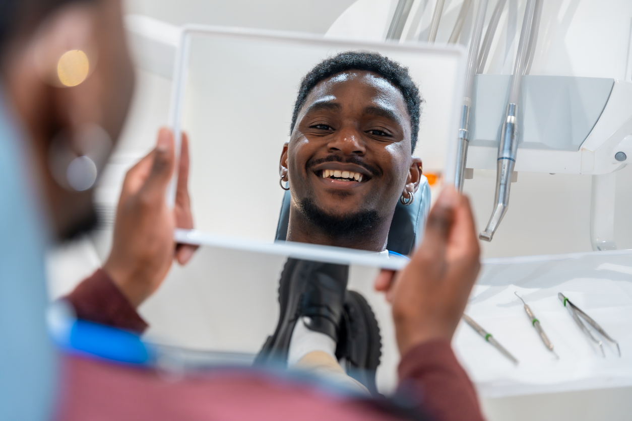 Young Man Admiring His Perfect Smile After Dental Treatment